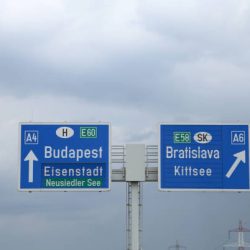 large highway sign on the border between Hungary and Slovakia with directions to go to Budapest or Bratislava City