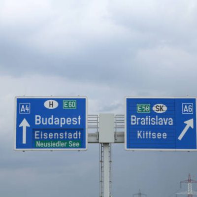 large highway sign on the border between Hungary and Slovakia with directions to go to Budapest or Bratislava City